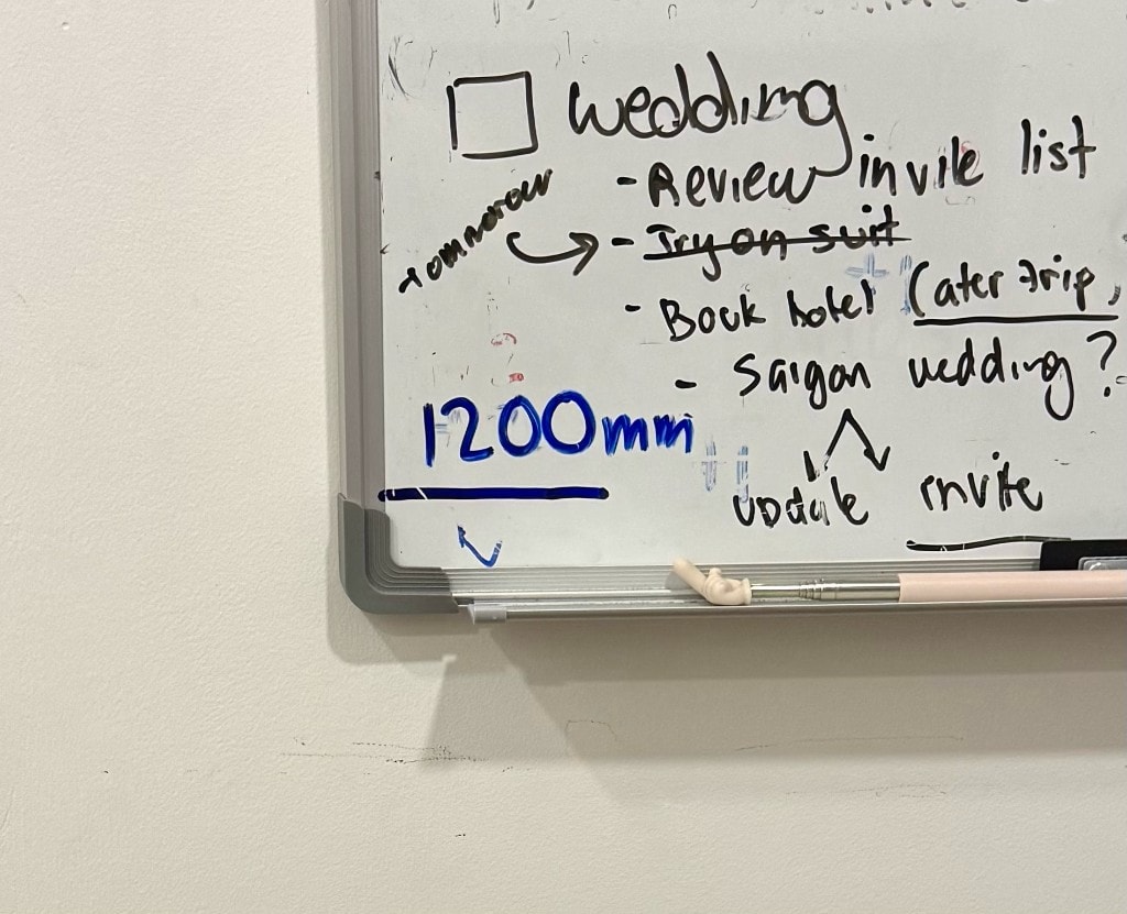 Whiteboard with a blue 1200mm reach-height line marked for wheelchair accessibility